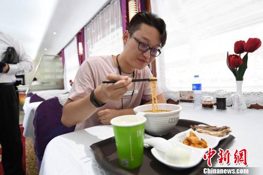 圖為旅客在列車上享用正宗牛肉面?！钇G敏 攝