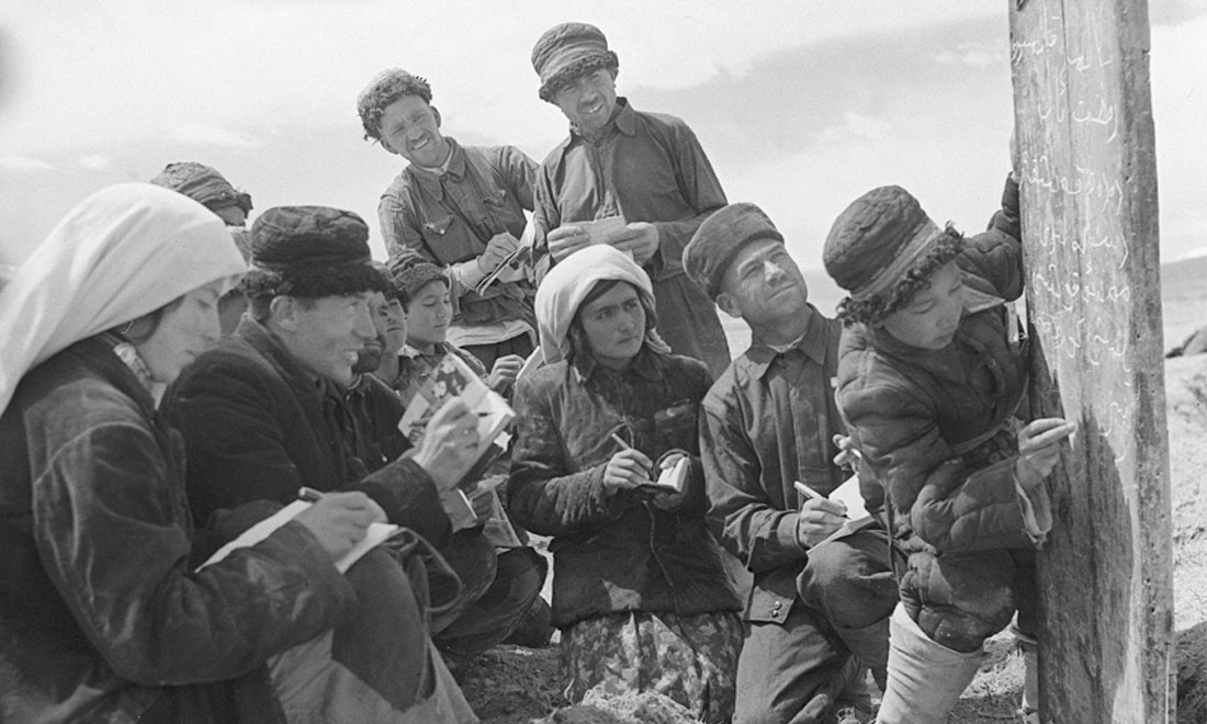 1960年6月，新疆慕士塔格峰下，大人們?cè)谛W(xué)生幫助下學(xué)習(xí)文化。新華社記者武純展攝